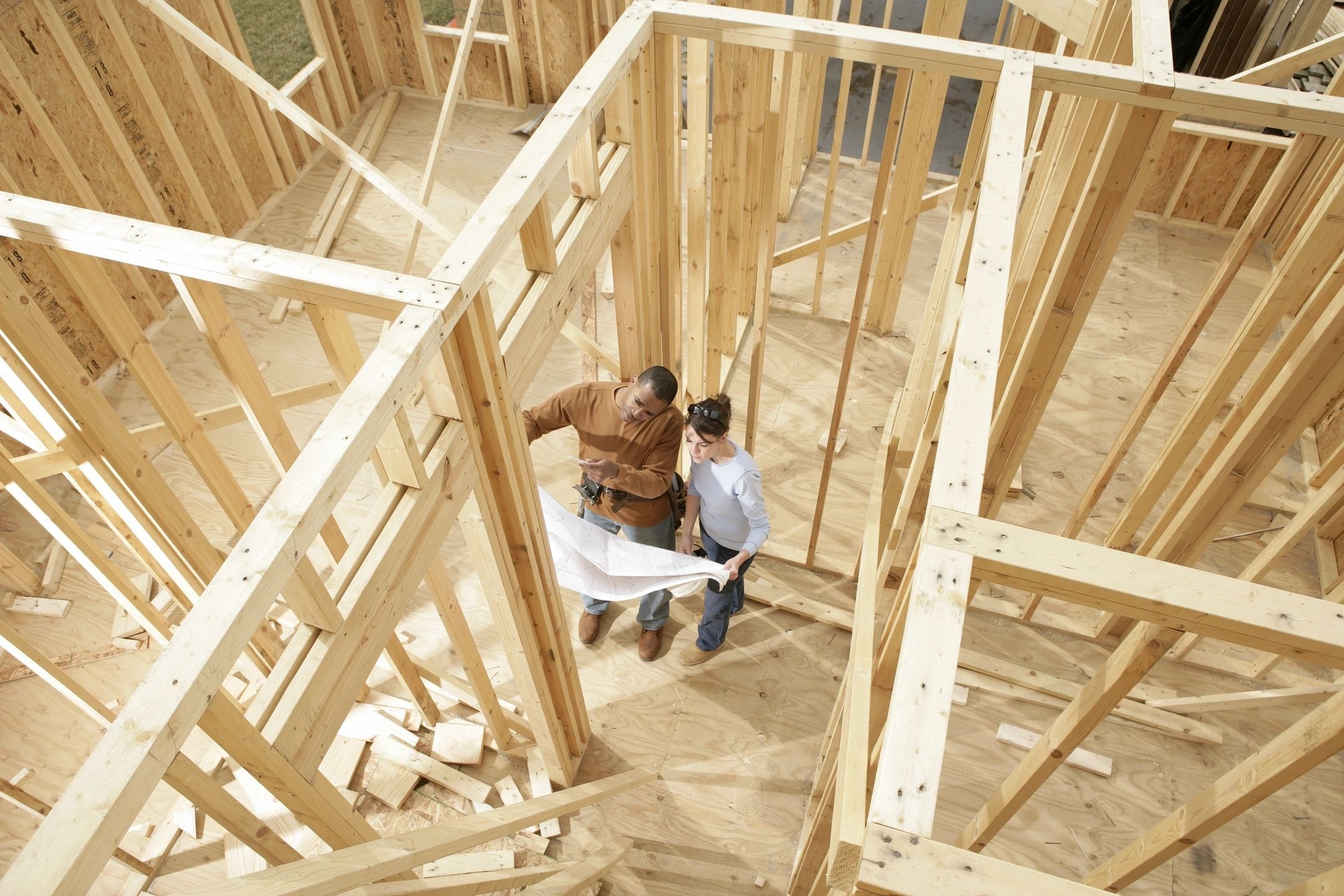 Construction workers reviewing blueprints
